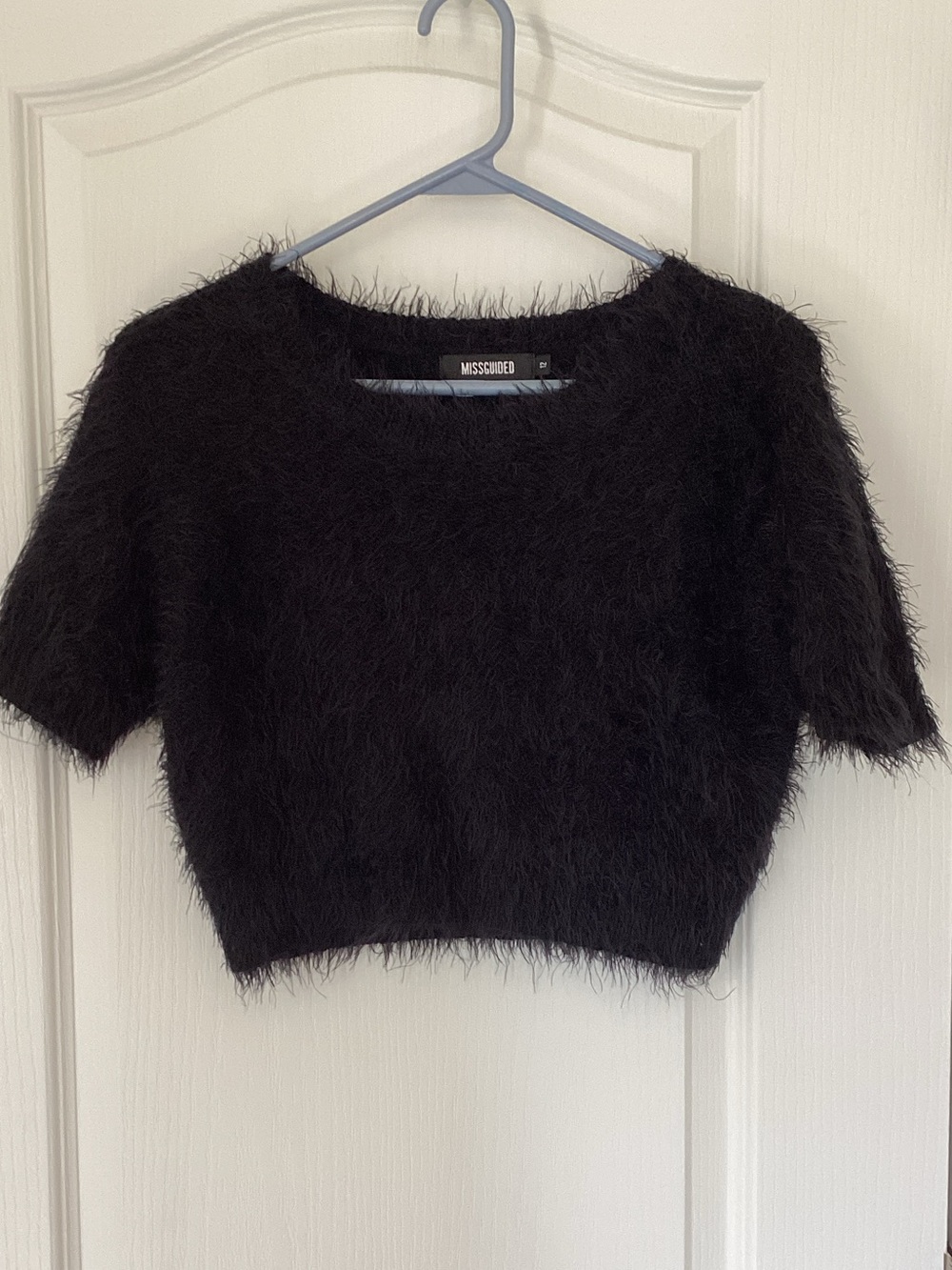 Cropped black short sleeve eyelash sweater.